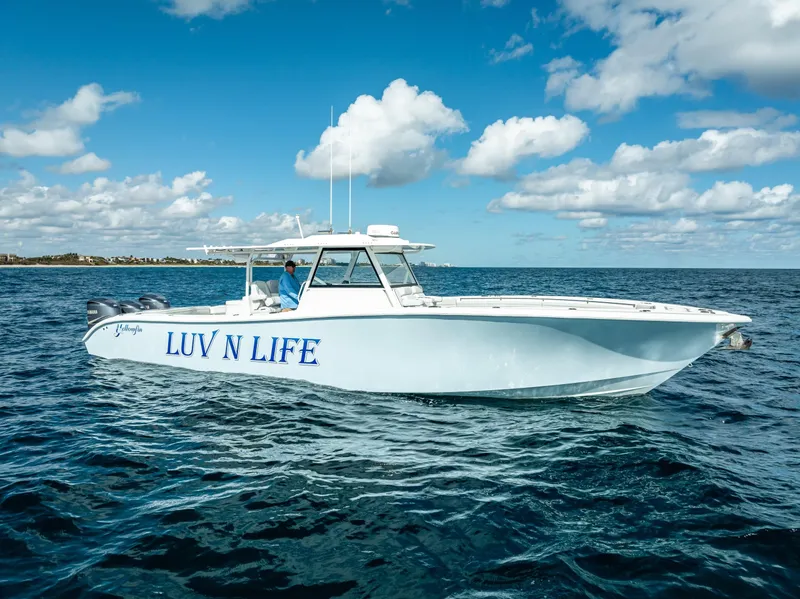 Slide: The Image of 2018 Yellowfin 42 boat named "LUV N LIFE" cruising on open water under blue skies. - 16