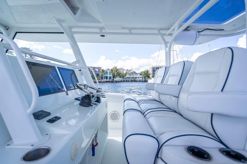 Slide: The Image of Interior view of 2018 Yellowfin 42 boat with luxurious seating and waterfront backdrop. - 26