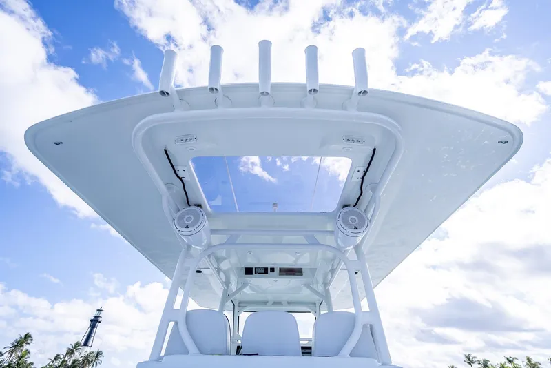 Slide: The Image of 2018 Yellowfin 42 boat with sleek design and spacious deck under a clear blue sky. - 29