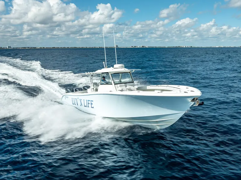 Slide: The Image of 2018 Yellowfin 42 boat cruising on open ocean under blue sky. - 3