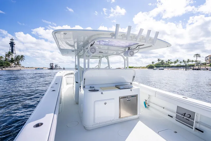 Slide: The Image of 2018 Yellowfin 42 boat on water, clear sky, lighthouse in background. - 31