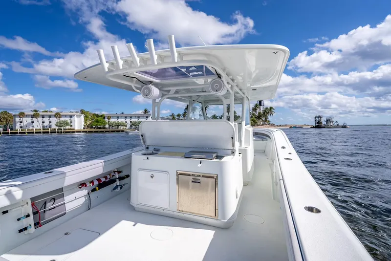 Slide: The Image of 2018 Yellowfin 42 boat on water, featuring spacious deck and modern amenities under a clear sky. - 35