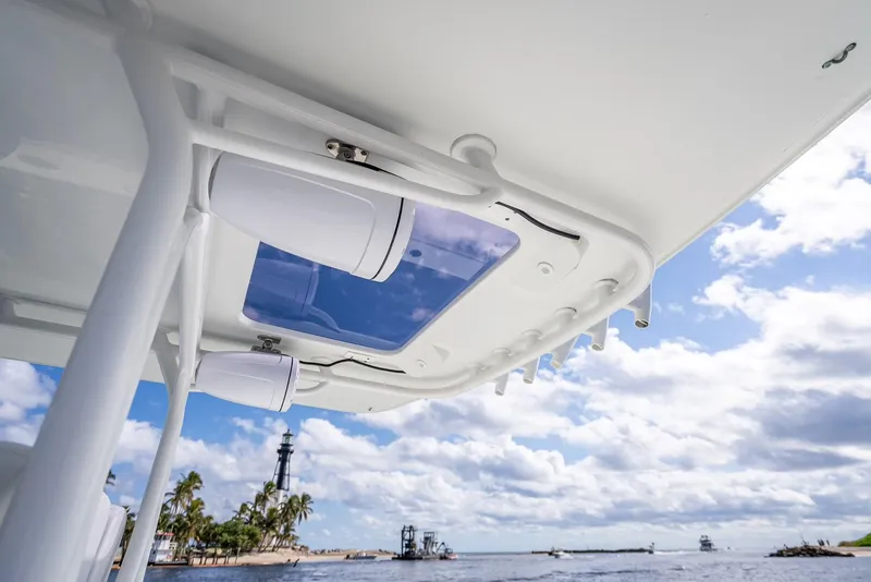 Slide: The Image of 2018 Yellowfin 42 boat canopy with speakers, ocean view, and cloudy sky. - 41