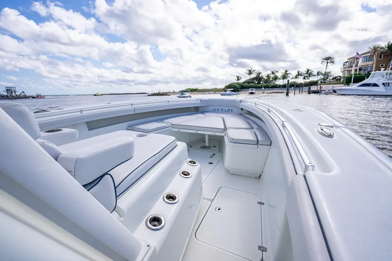 Slide: The Image of 2018 Yellowfin 42 boat with spacious seating, docked by a scenic waterfront. - 43