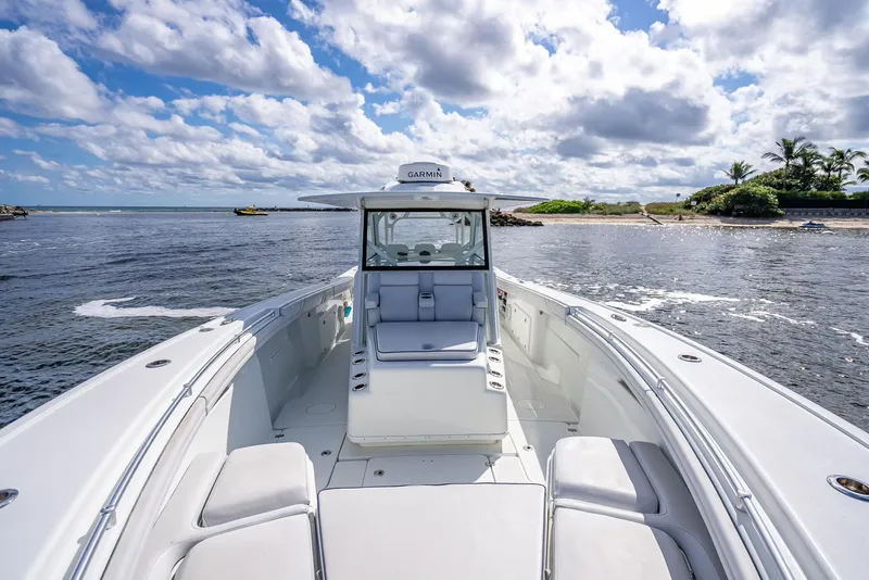 Slide: The Image of 2018 Yellowfin 42 boat on open water with scenic coastal background. - 44