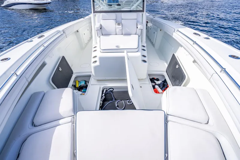 Slide: The Image of 2018 Yellowfin 42 boat interior with open storage compartments on calm water. - 48