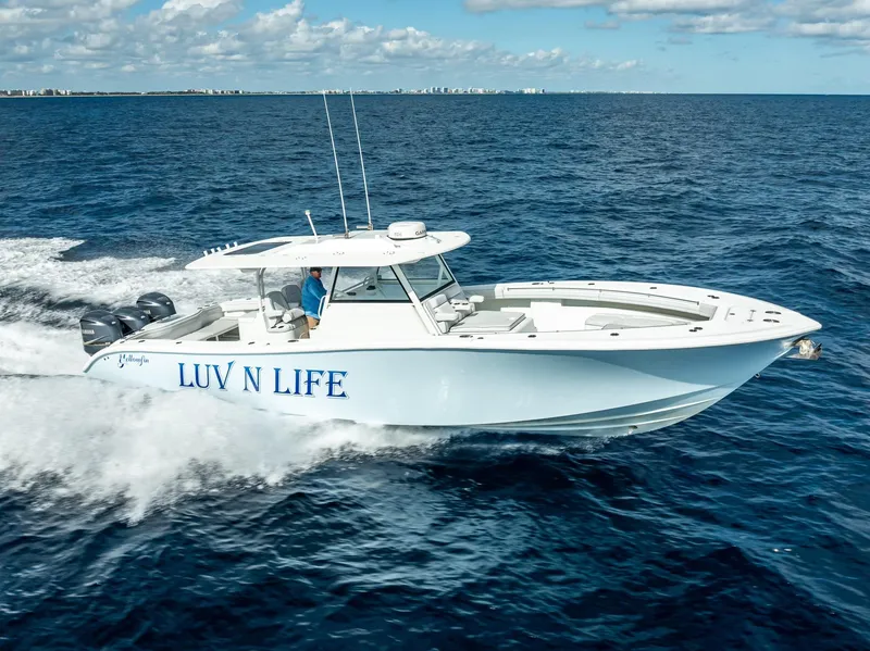 Slide: The Image of 2018 Yellowfin 42 boat cruising on open ocean under clear skies. - 5