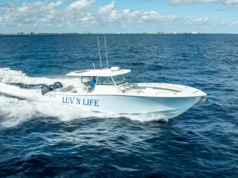 Slide: The Image of 2018 Yellowfin 42 boat "LUV N LIFE" cruising on open ocean under blue sky. - 6