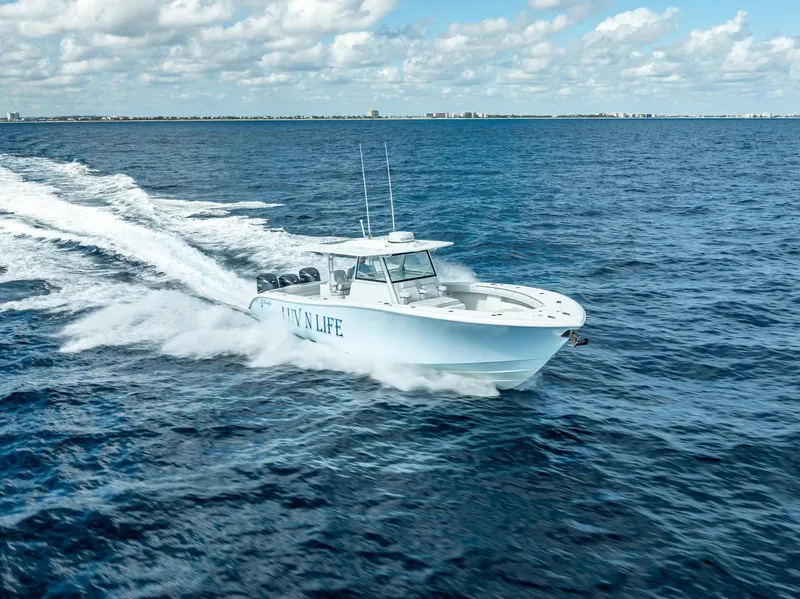 Slide: The Image of 2018 Yellowfin 42 boat cruising on open ocean under blue sky. - 7