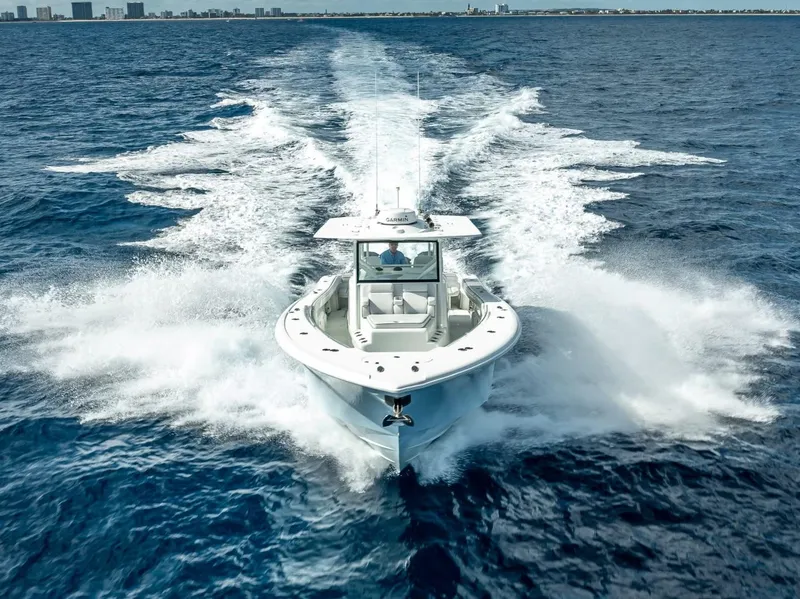 Slide: The Image of 2018 Yellowfin 42 boat cruising on open ocean, creating a dynamic water trail. - 8