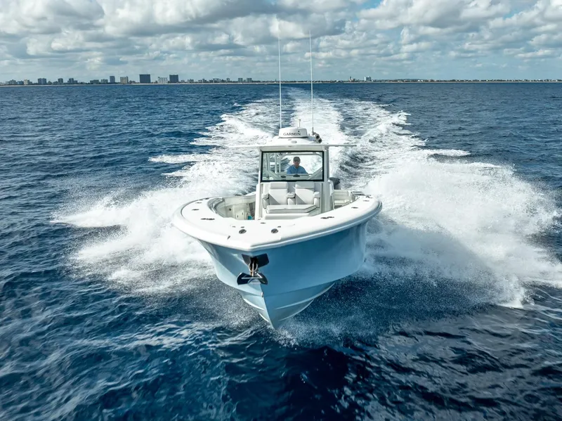 Slide: The Image of 2018 Yellowfin 42 boat cruising on open ocean under cloudy sky. - 9