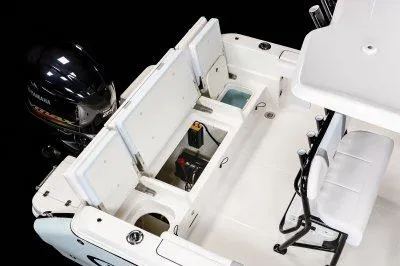 Slide: The Image of 2025 Robalo R232EXP boat interior with open storage compartments and Yamaha outboard motor. - 5