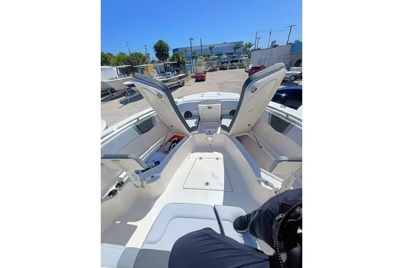 Slide: The Image of 2025 Robalo 300 boat interior with open storage compartments, docked outdoors. - 8