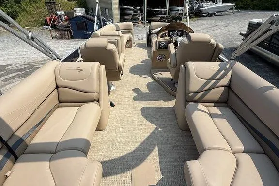 Slide: The Image of 2018 Bennington 23GSRFB pontoon boat with beige seating and spacious interior layout. - 10