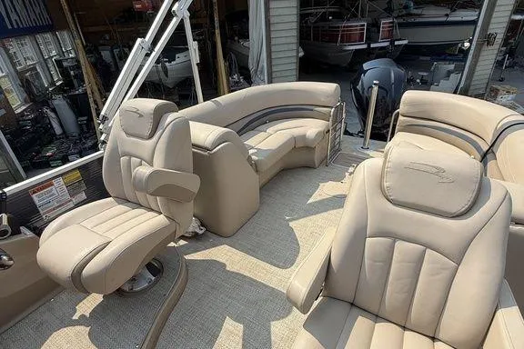 Slide: The Image of 2018 Bennington 23GSRFB pontoon boat interior with beige seating and helm. - 13