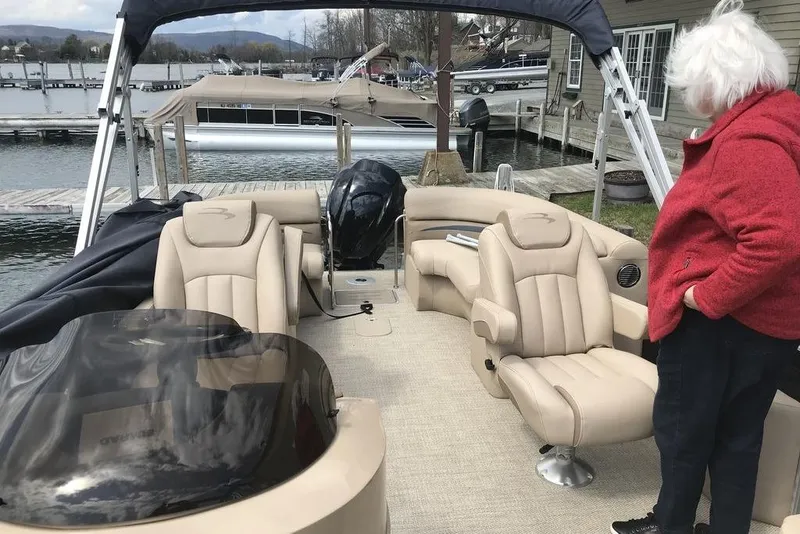 Slide: The Image of 2018 Bennington 23GSRFB pontoon boat with beige seating, docked by a marina. - 16