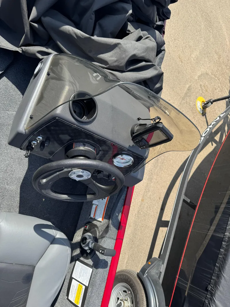 Slide: The Image of 2025 Tracker Bass Tracker Classic XL dashboard with steering wheel and gauges, parked on a trailer. - 12