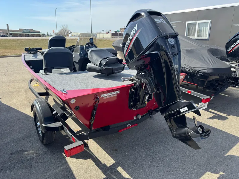 Slide: The Image of 2025 Tracker Bass Tracker Classic XL boat with Mercury outboard motor, parked on a trailer. - 3