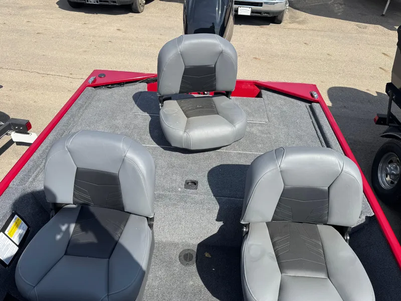 Slide: The Image of 2025 Tracker Bass Tracker Classic XL boat with three gray seats on deck. - 8