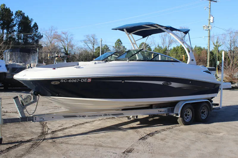 The Image of 2016 Sea Ray 240 Sundeck boat on trailer, parked outdoors. - 0