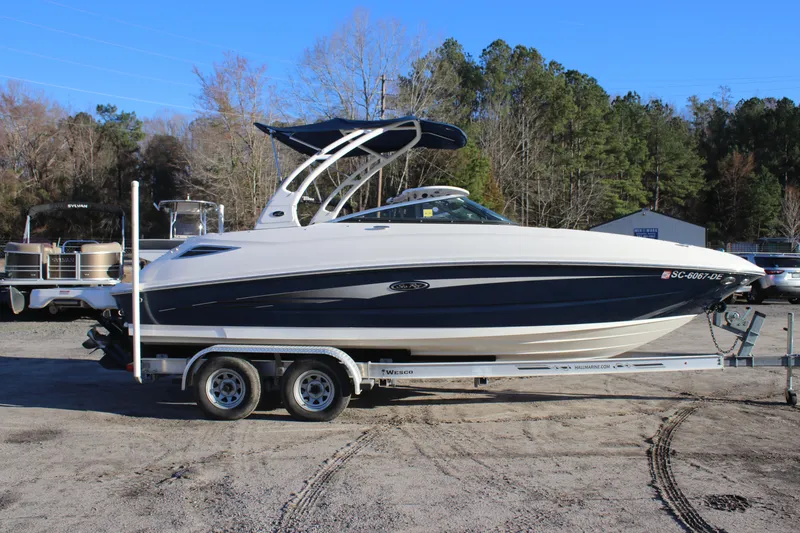 Slide: The Image of 2016 Sea Ray 240 Sundeck boat on trailer, parked outdoors. - 1