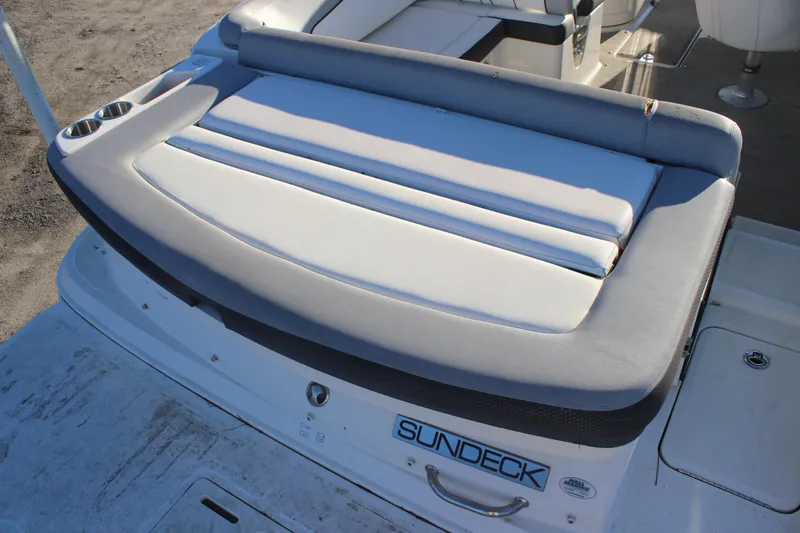 Slide: The Image of 2016 Sea Ray 240 Sundeck boat with cushioned seating and sundeck logo. - 12