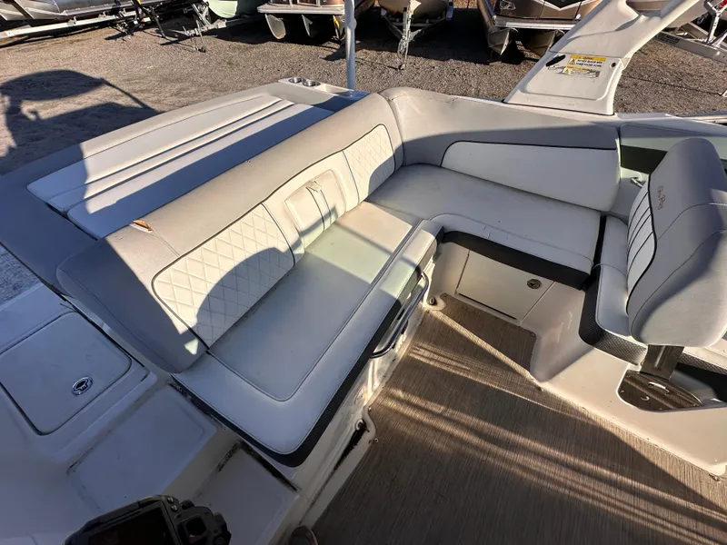 Slide: The Image of 2016 Sea Ray 240 Sundeck interior seating with beige upholstery and modern design. - 4