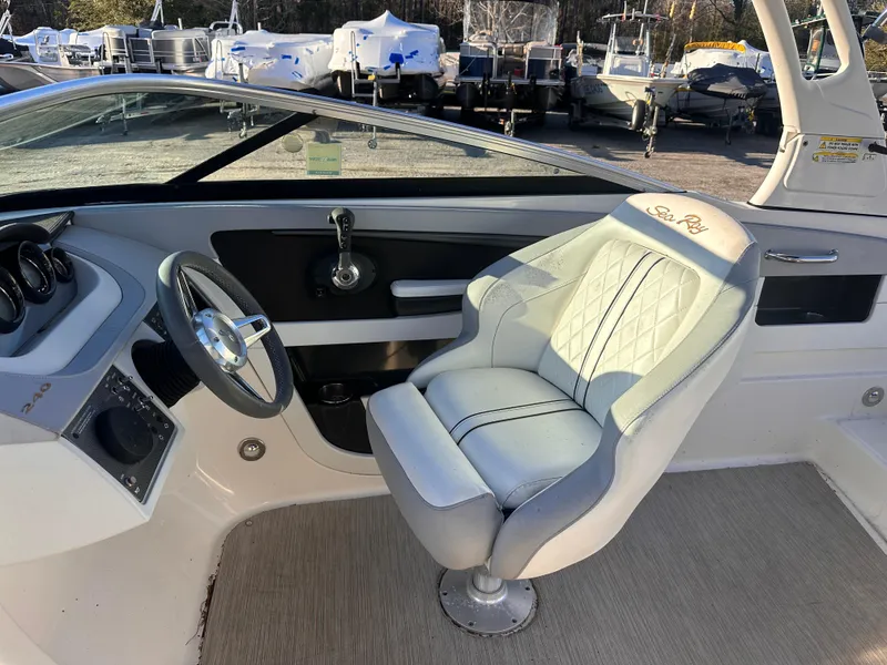 Slide: The Image of 2016 Sea Ray 240 Sundeck interior with steering wheel and captain's chair. - 7