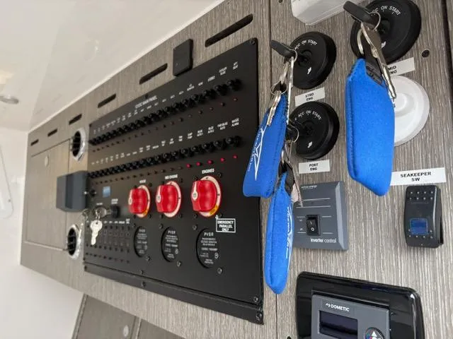 Slide: The Image of Control panel of 2025 Tidewater 380 CC Adventure boat with keys and switches. - 10