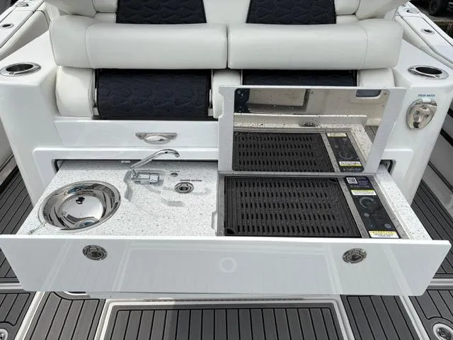 Slide: The Image of 2025 Tidewater 380 CC Adventure boat with sleek onboard kitchen amenities. - 13