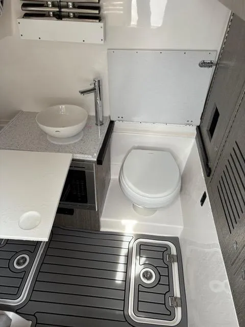 Slide: The Image of 2025 Tidewater 380 CC Adventure boat interior with modern bathroom amenities. - 14