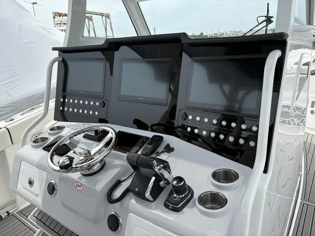 Slide: The Image of 2025 Tidewater 380 CC Adventure helm with advanced navigation displays and controls. - 4