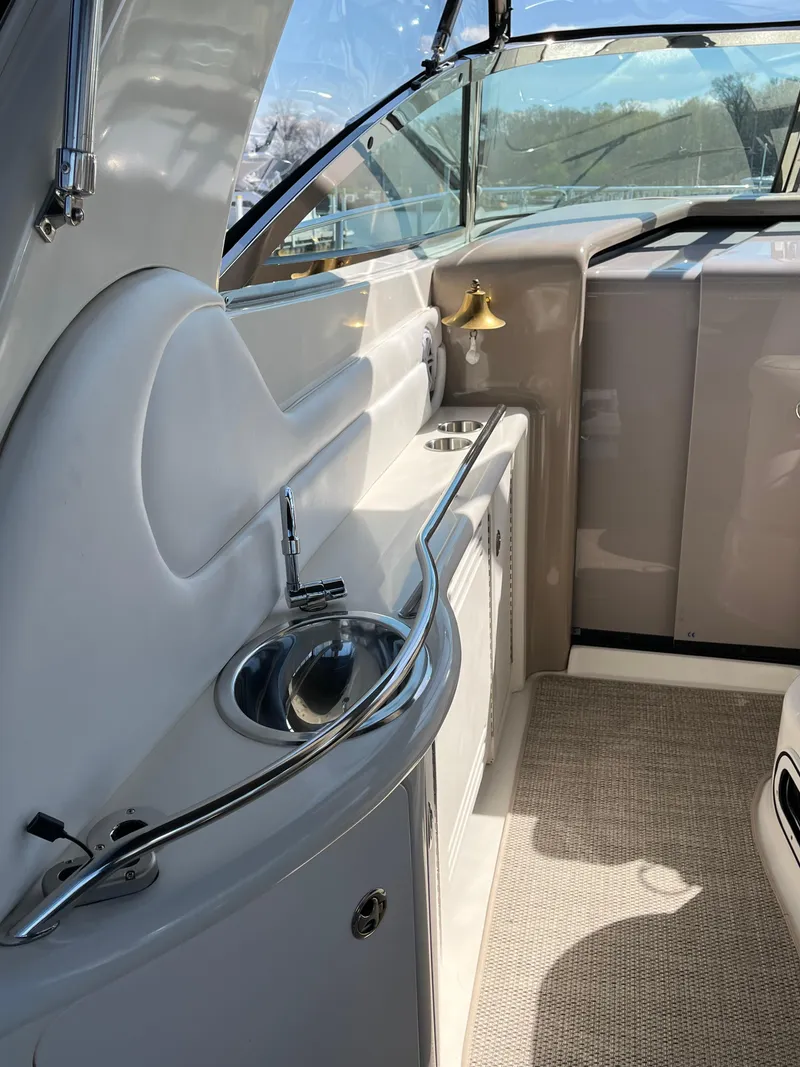 Slide: The Image of 2003 Sea Ray 380 Sundancer interior with sink and counter, featuring sleek design. - 11