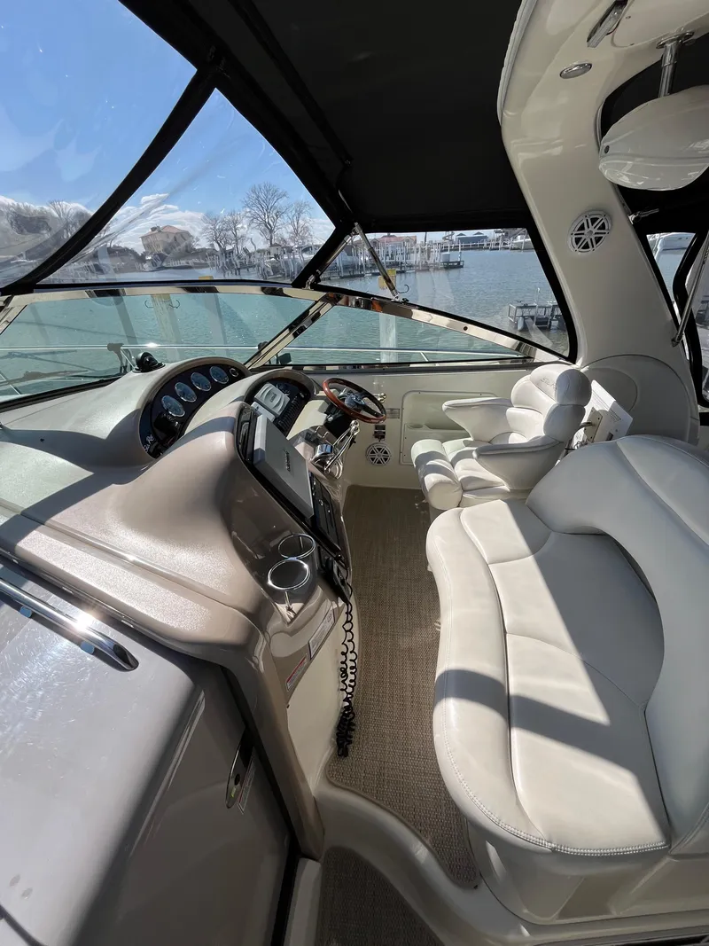 Slide: The Image of 2003 Sea Ray 380 Sundancer cockpit with luxurious seating and modern controls. - 12