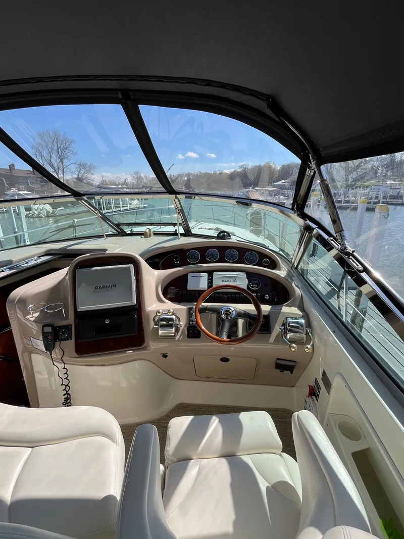 Slide: The Image of Helm of 2003 Sea Ray 380 Sundancer with Garmin navigation system and leather seating. - 19