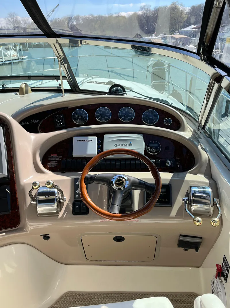 Slide: The Image of 2003 Sea Ray 380 Sundancer helm with Garmin and Mercury controls, wooden steering wheel. - 20