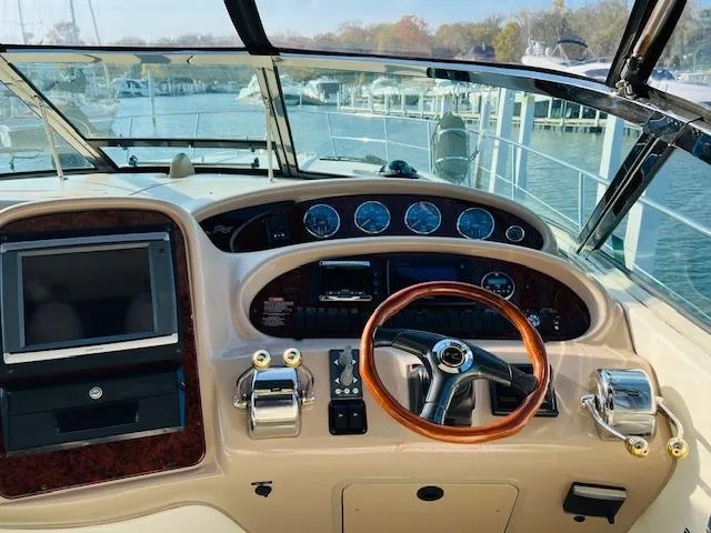 Slide: The Image of Cockpit of 2003 Sea Ray 380 Sundancer with steering wheel and control panel. - 22