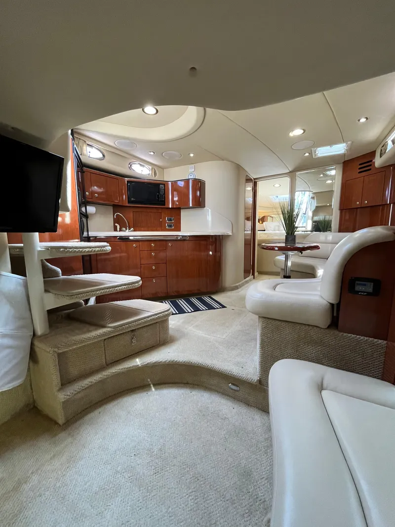 Slide: The Image of Luxurious interior of a 2003 Sea Ray 380 Sundancer yacht, featuring elegant wood cabinetry. - 26