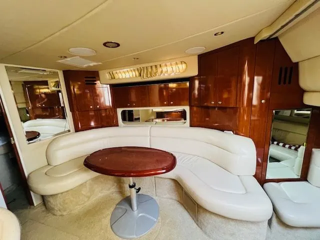 Slide: The Image of Luxurious interior of 2003 Sea Ray 380 Sundancer yacht with elegant seating and wooden finishes. - 28