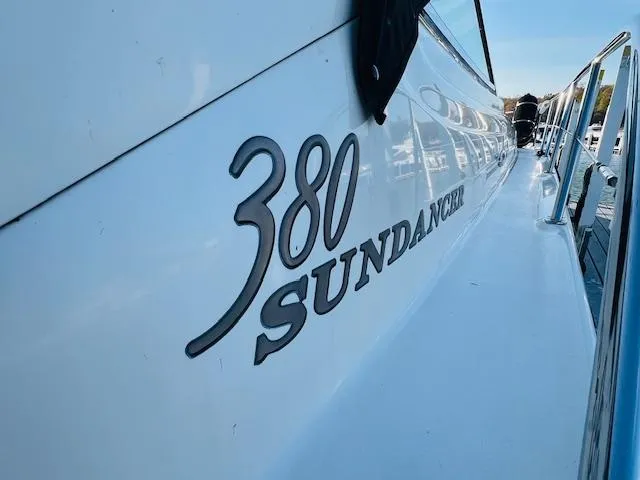 Slide: The Image of 2003 Sea Ray 380 Sundancer boat side view with model name displayed. - 3