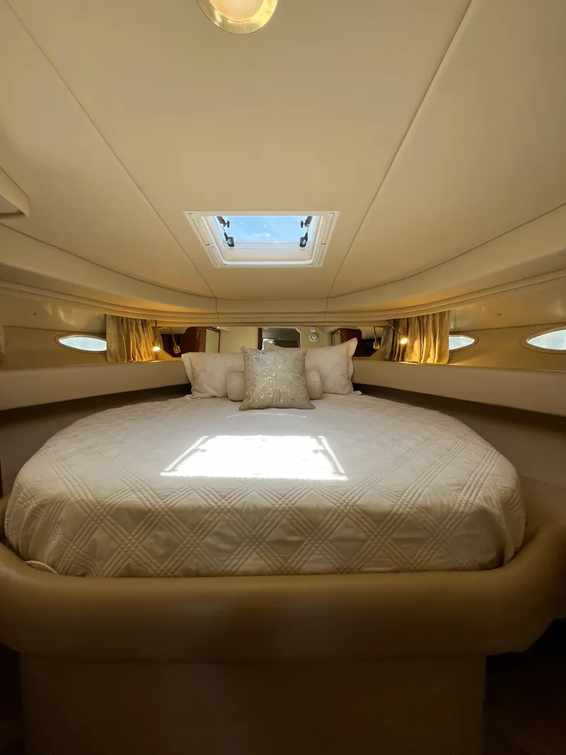 Slide: The Image of Luxurious cabin interior of 2003 Sea Ray 380 Sundancer with skylight and plush bedding. - 31
