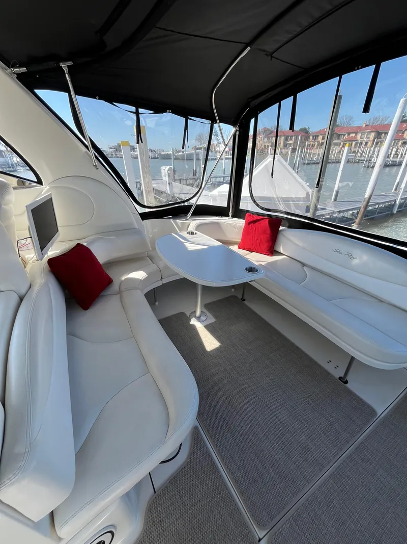 Slide: The Image of Luxurious interior of 2003 Sea Ray 380 Sundancer yacht with white seating and red cushions. - 7