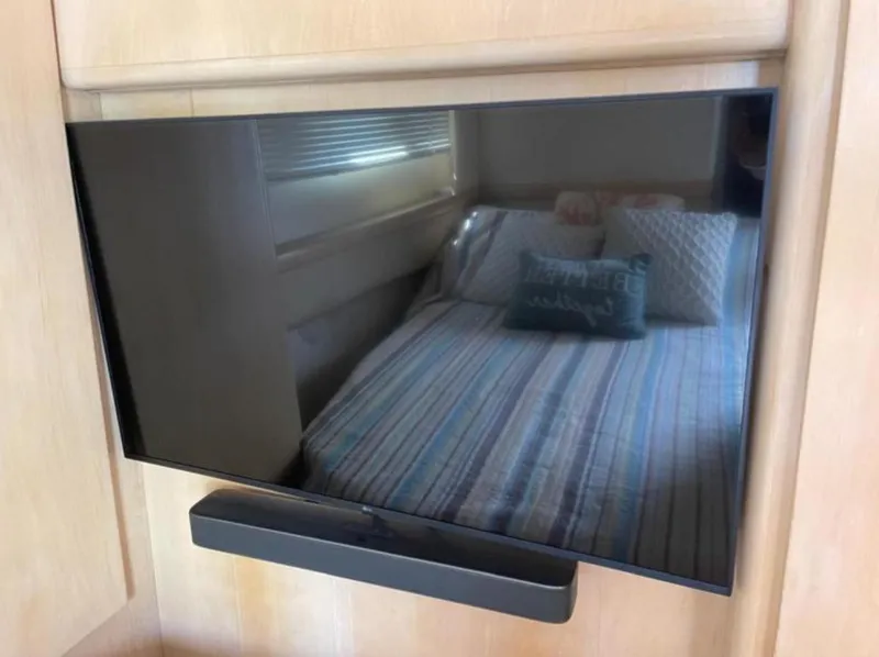 Slide: The Image of Flat-screen TV with soundbar in 1997 Carver 400 Cockpit Motor Yacht cabin. - 11