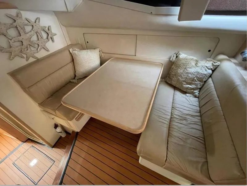Slide: The Image of Interior of 1997 Carver 400 Cockpit Motor Yacht with beige seating and table. - 14