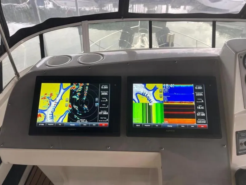 Slide: The Image of 1997 Carver 400 Cockpit Motor Yacht dashboard with dual navigation screens. - 16