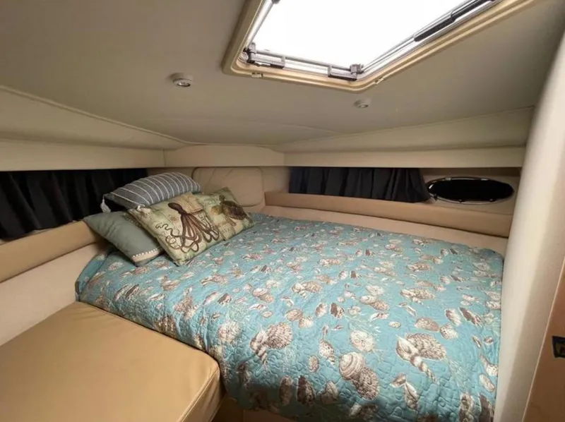 Slide: The Image of Cozy bedroom in 1997 Carver 400 Cockpit Motor Yacht with nautical-themed bedding. - 17