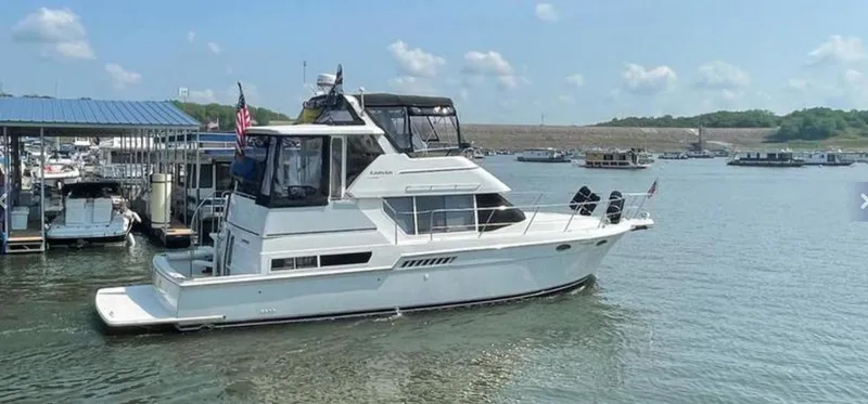 Slide: The Image of 1997 Carver 400 Cockpit Motor Yacht docked on a sunny day. - 3
