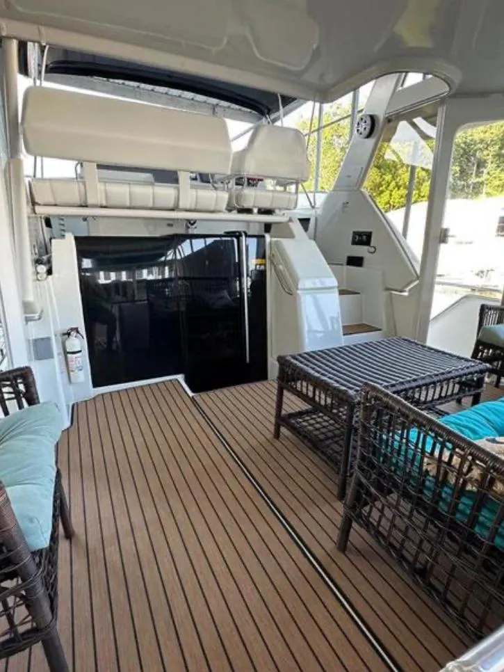 Slide: The Image of 1997 Carver 400 Cockpit Motor Yacht with spacious deck and comfortable seating. - 6