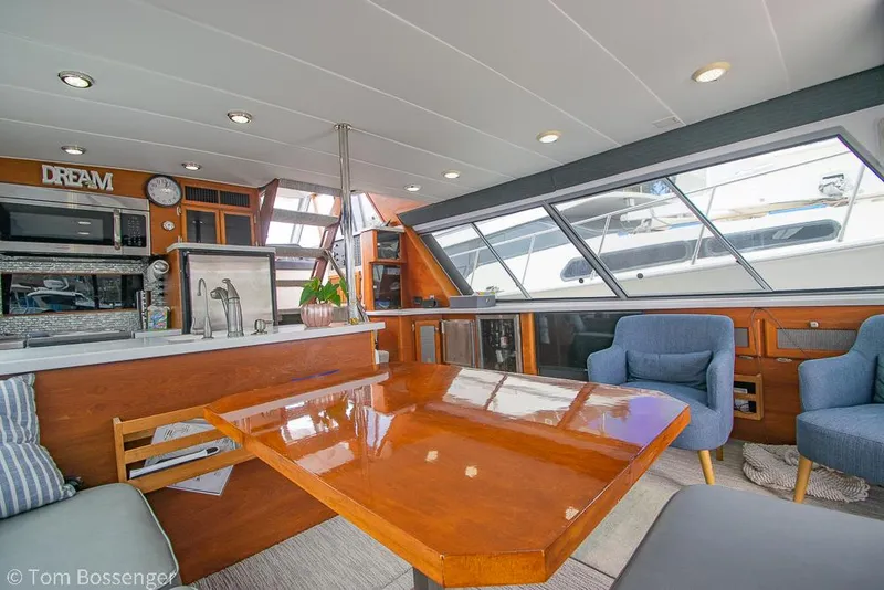 Slide: The Image of Interior of 1986 Bayliner 4588 Pilothouse yacht with modern furnishings and large windows. - 12