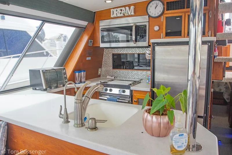 Slide: The Image of Interior of 1986 Bayliner 4588 Pilothouse yacht kitchen with modern appliances and decor. - 15
